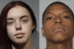 Two mugshots side by side. The person on the left has long, dark red hair and is looking directly at the camera. The person on the right has short hair and visible tattoos on the neck, also looking directly at the camera.