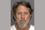 Mugshot of a middle-aged man with light hair, a beard, and a serious expression, photographed against a plain gray background.