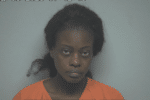A woman wearing an orange prison jumpsuit stands against a plain background in a mugshot dated May 19, 2023, at 07:42:45, as indicated by the timestamp at the top of the image.